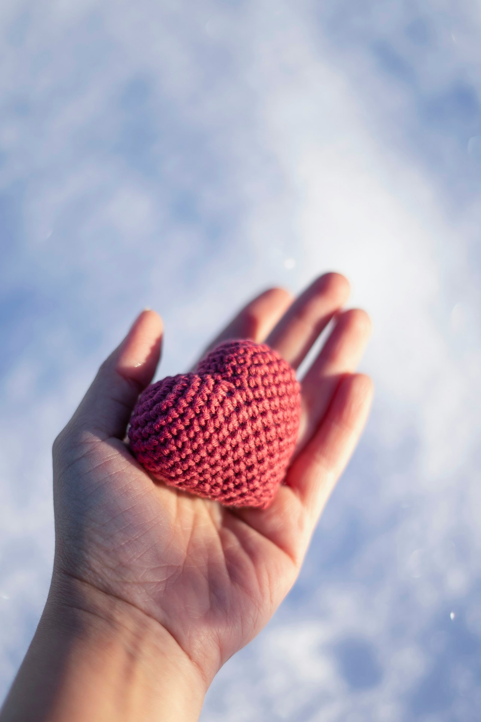 Hand holding a crocheted heart